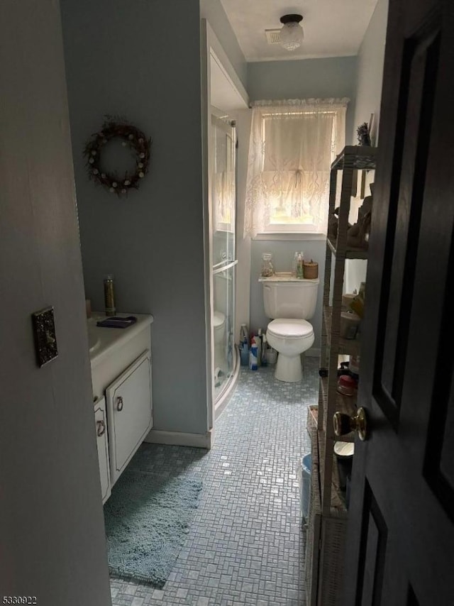 bathroom featuring tile patterned floors, vanity, and toilet