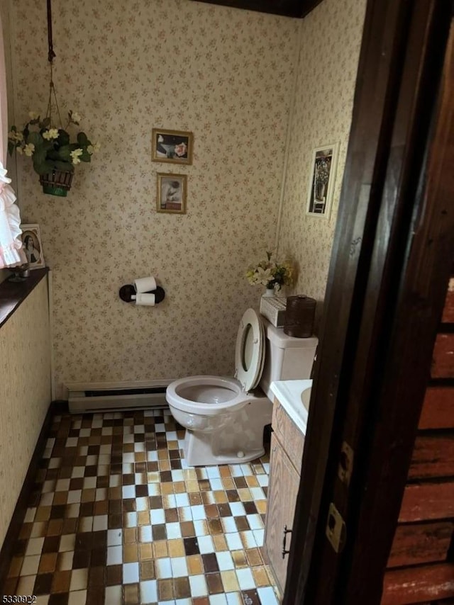 bathroom with vanity, toilet, and baseboard heating