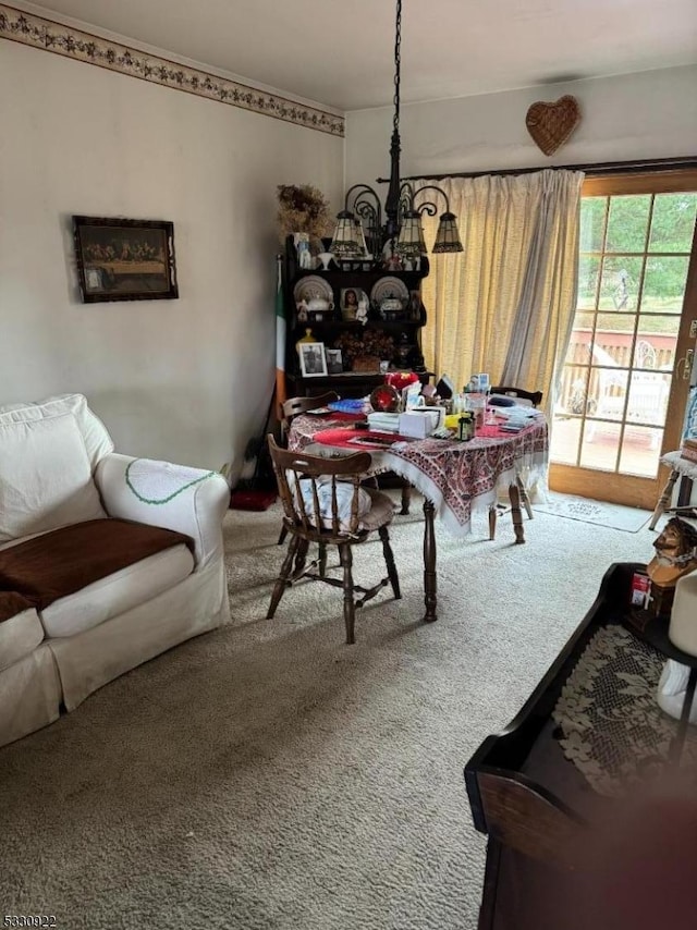 dining space with carpet floors and an inviting chandelier