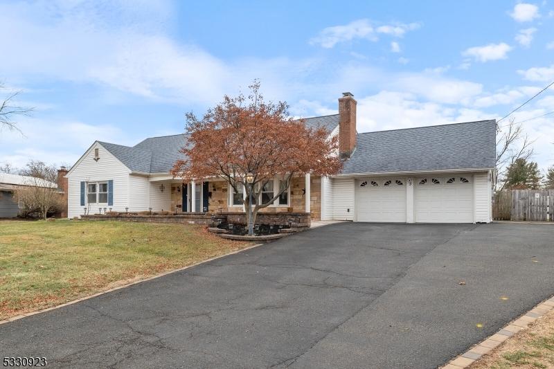 view of front of house with a garage and a front lawn