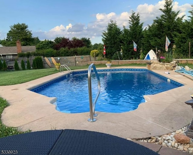 view of pool featuring a lawn and a patio area