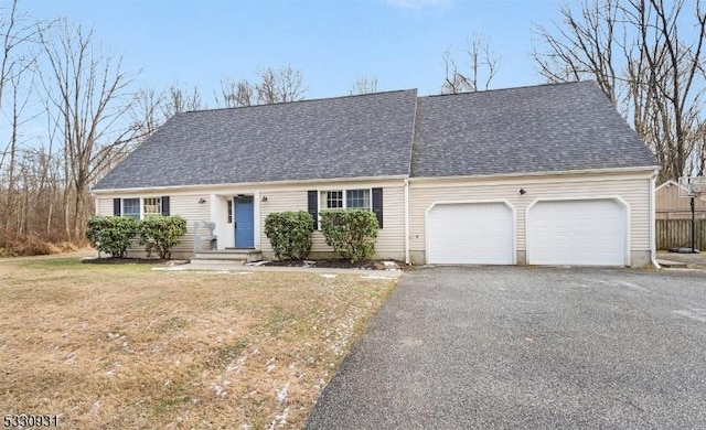 view of front of property with a garage and a front lawn