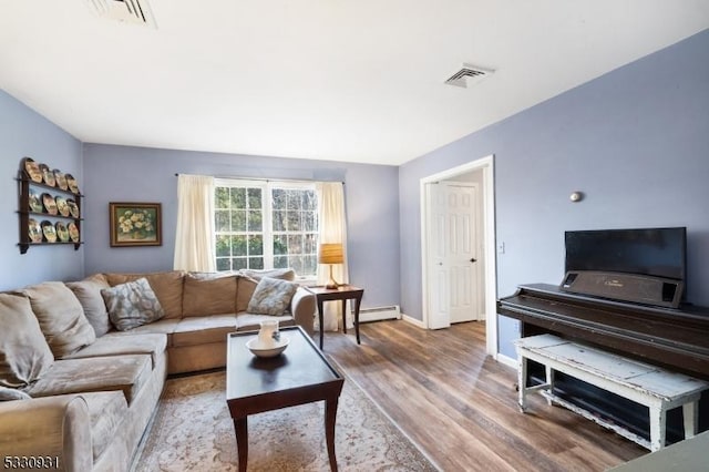 living room with hardwood / wood-style floors and baseboard heating