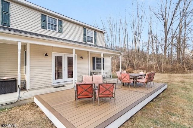 deck featuring a yard and french doors