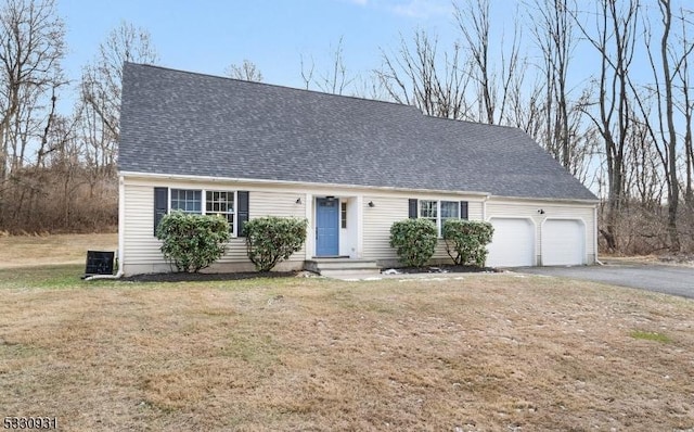 cape cod-style house with a front yard and a garage