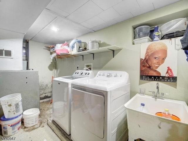 laundry room with washing machine and dryer and sink