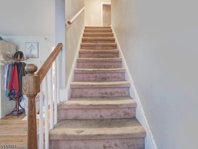 stairs featuring hardwood / wood-style flooring