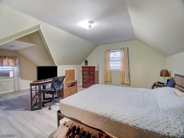 bedroom featuring hardwood / wood-style floors, cooling unit, and vaulted ceiling