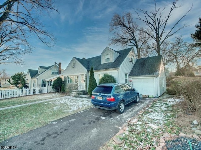 cape cod house featuring a garage