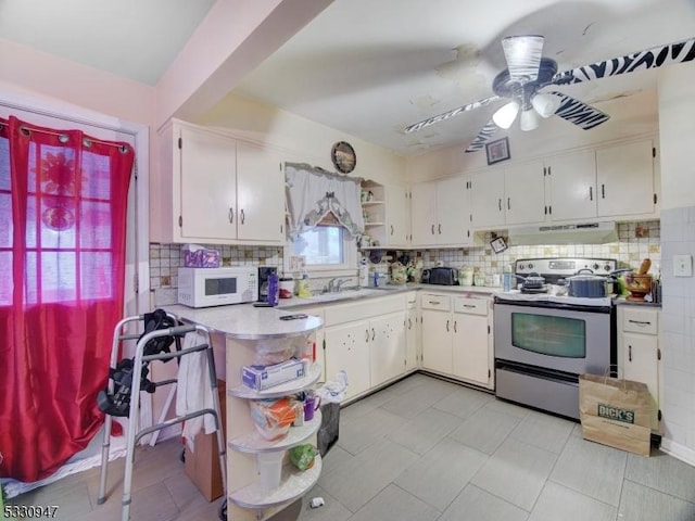 kitchen featuring backsplash, electric stove, white cabinetry, and ceiling fan