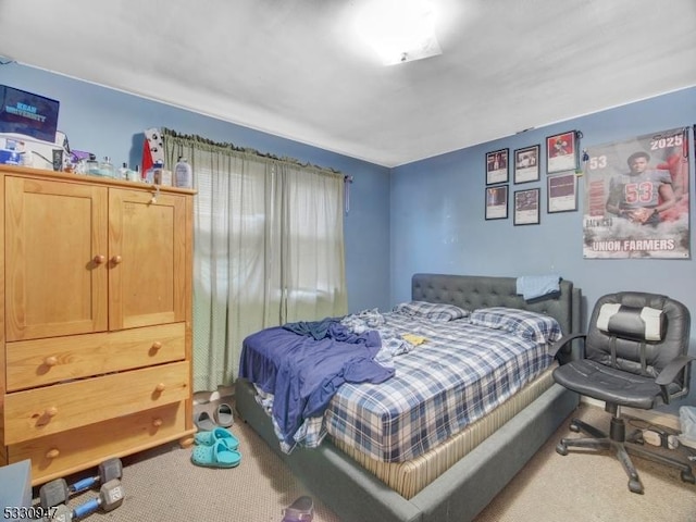 bedroom featuring light carpet