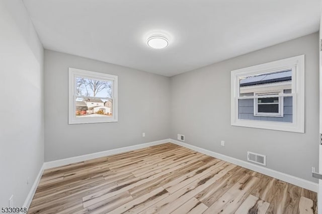 unfurnished room with light hardwood / wood-style floors