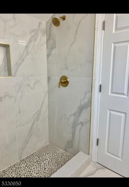 bathroom with a tile shower