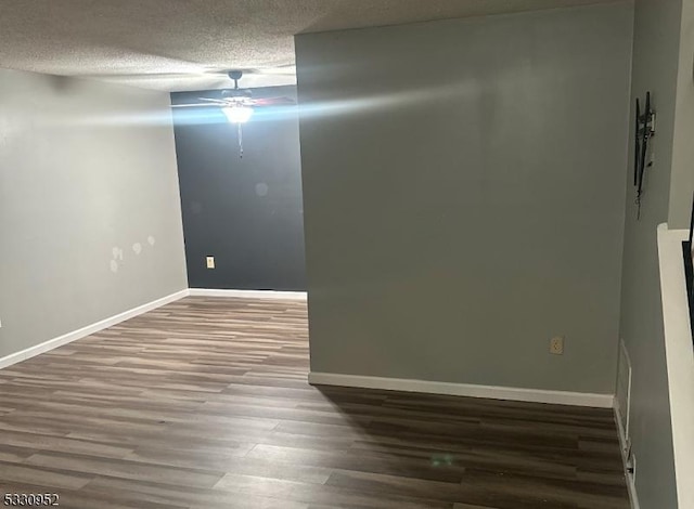 unfurnished room with wood-type flooring, a textured ceiling, and ceiling fan