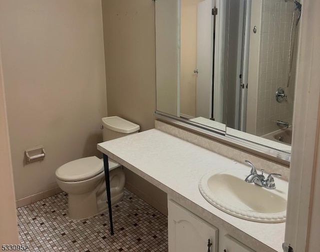 full bathroom featuring tile patterned flooring, vanity, tiled shower / bath combo, and toilet