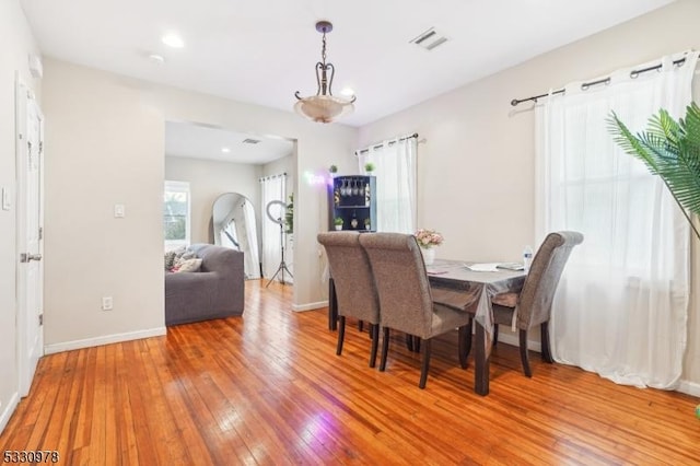 dining room with plenty of natural light and hardwood / wood-style flooring