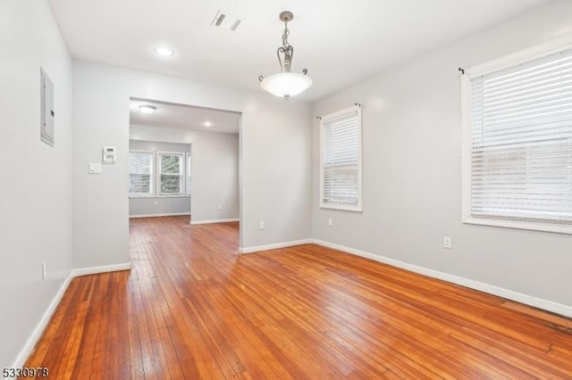 spare room featuring wood-type flooring