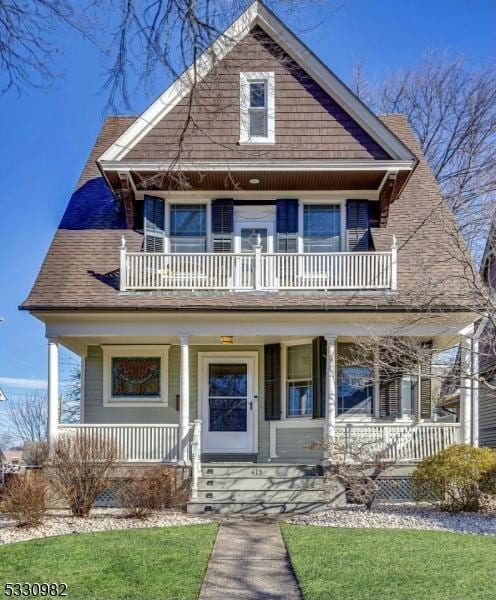 view of front of home featuring a balcony and covered porch