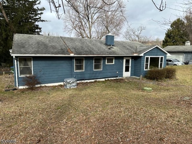 back of house with a lawn