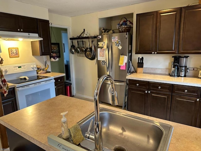 kitchen with dark brown cabinets, white range with electric cooktop, stainless steel refrigerator, and sink