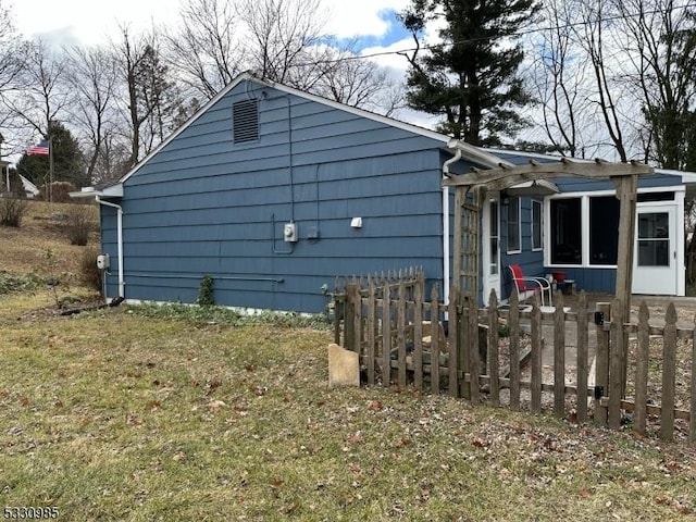 view of side of home featuring a lawn