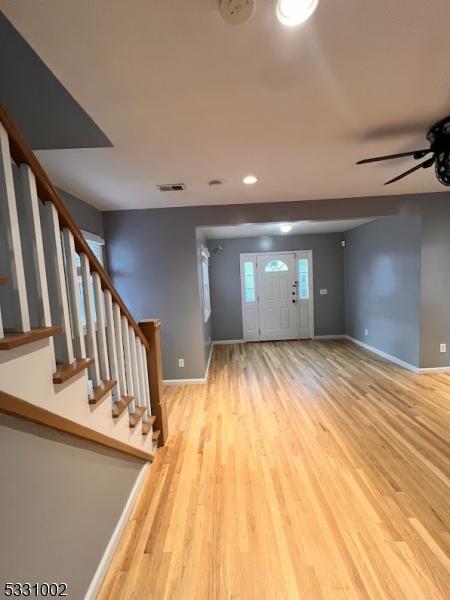 foyer with ceiling fan and light hardwood / wood-style flooring