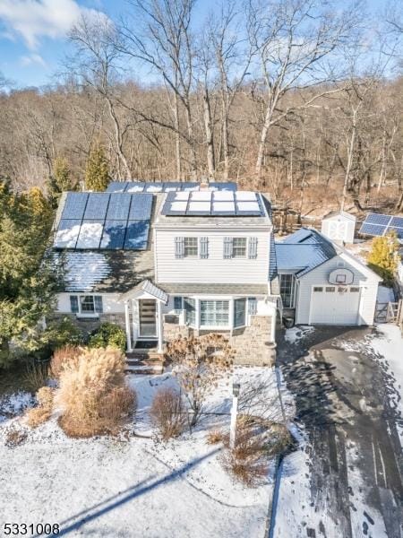 view of front facade featuring an outbuilding and solar panels