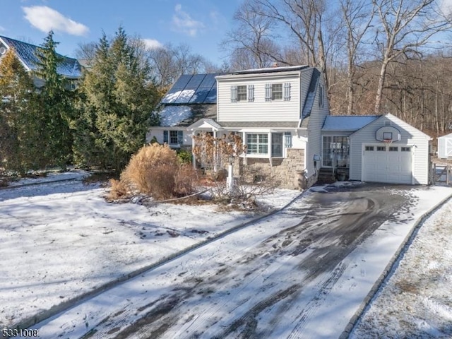 front of property featuring a garage and solar panels