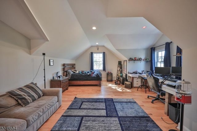 bedroom with lofted ceiling and light hardwood / wood-style flooring