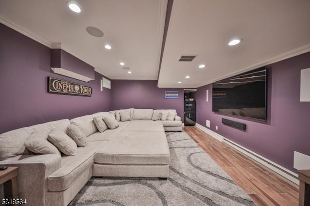 home theater featuring light hardwood / wood-style floors and crown molding