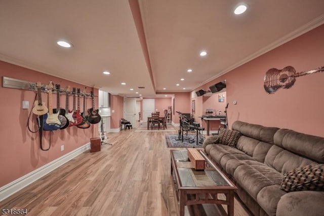 living room featuring crown molding and light hardwood / wood-style floors