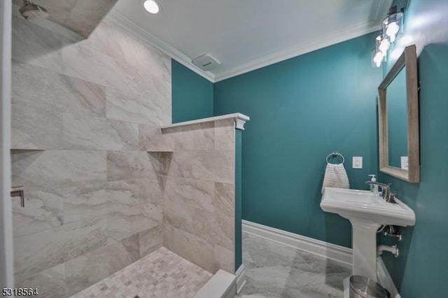 bathroom with a tile shower and crown molding