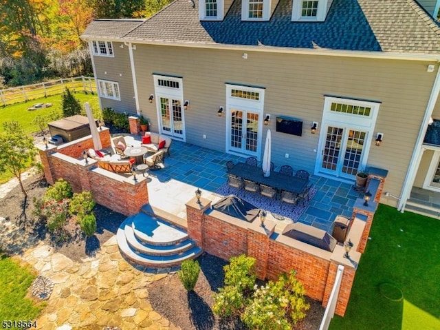 rear view of house with a patio area and french doors