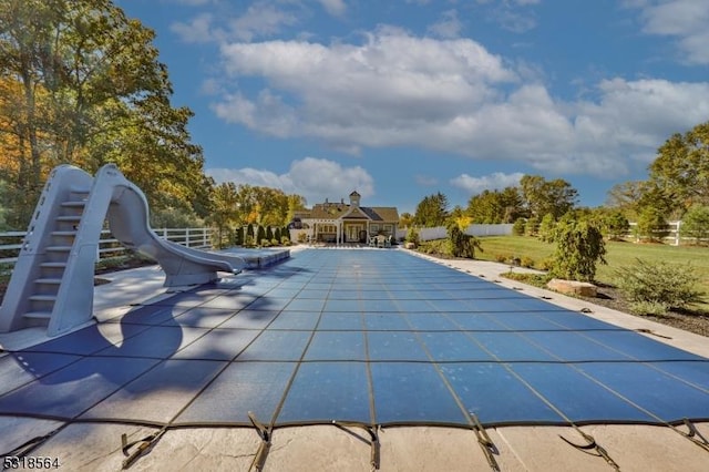 view of pool with a water slide