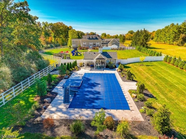 view of swimming pool featuring a lawn and a patio area