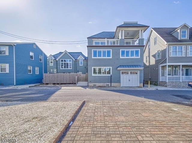 view of front of home with a balcony and a garage