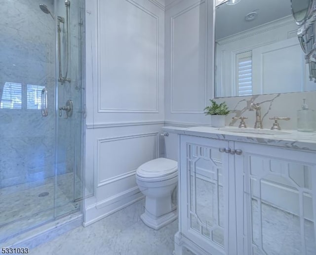 bathroom featuring walk in shower, vanity, and toilet