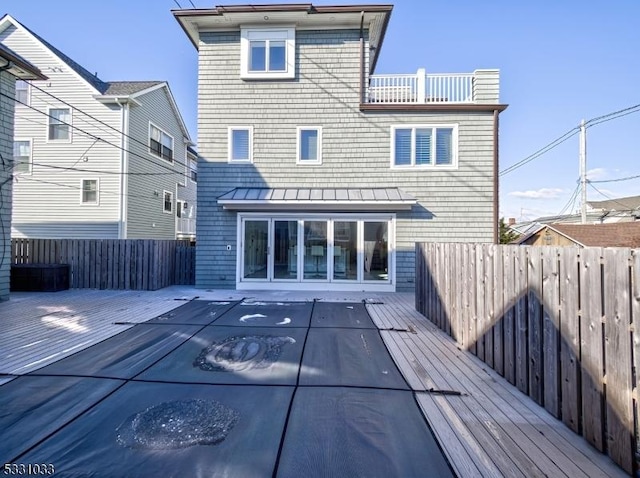 back of property featuring a wooden deck