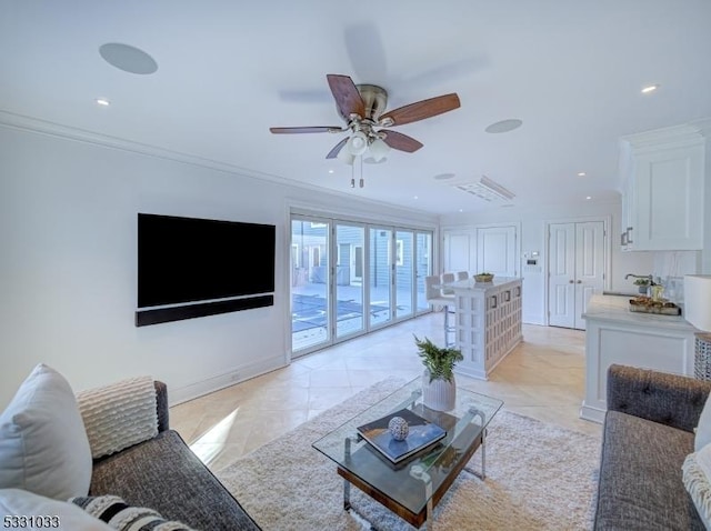 living room with ceiling fan, light tile patterned floors, and crown molding