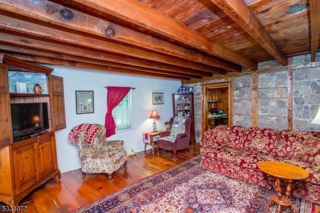 living room with hardwood / wood-style flooring and beam ceiling