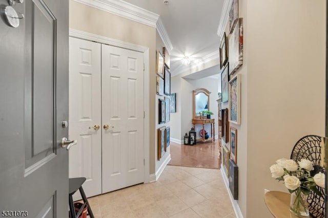 hall with ornamental molding and light tile patterned flooring