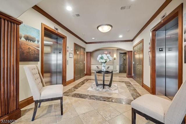 hallway with ornamental molding and elevator