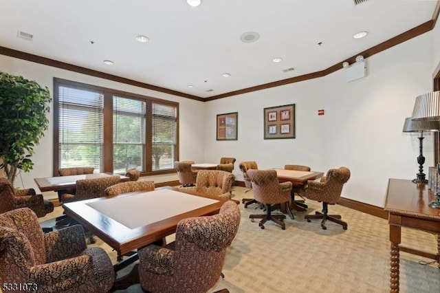 carpeted dining space with ornamental molding