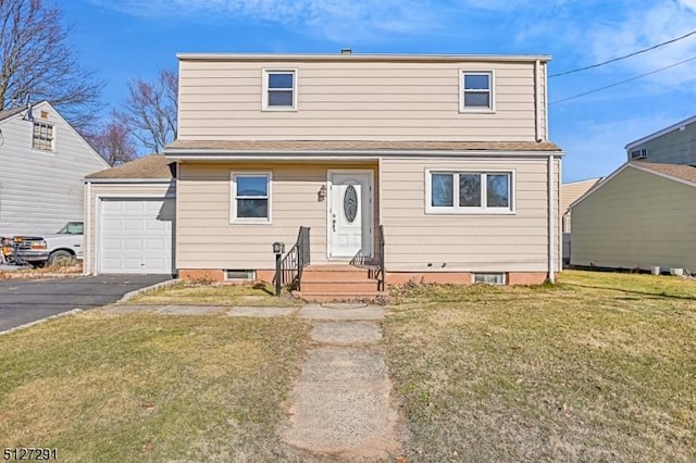 view of property with a front lawn and a garage