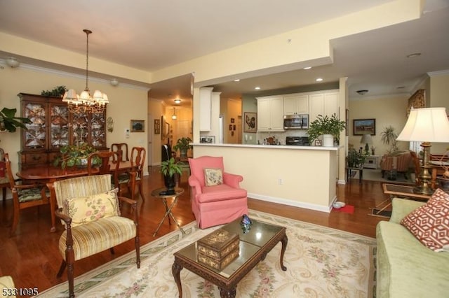 living room featuring ornamental molding, dark wood-type flooring, and a notable chandelier