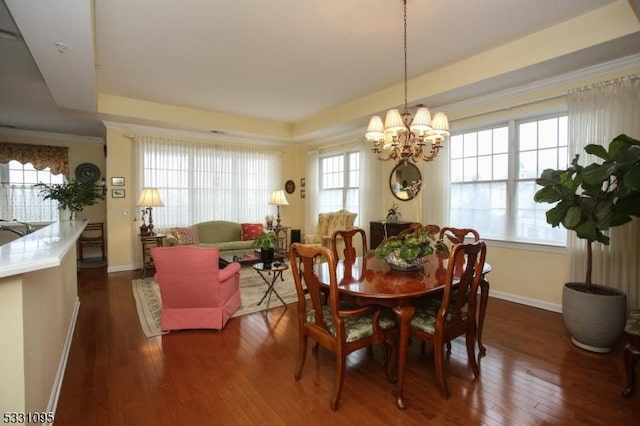 dining space with dark wood-type flooring and a notable chandelier