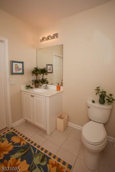 bathroom featuring tile patterned floors, vanity, and toilet