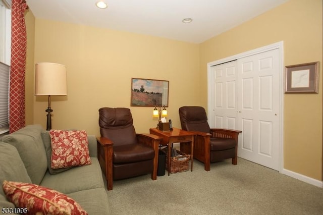 living area featuring light carpet