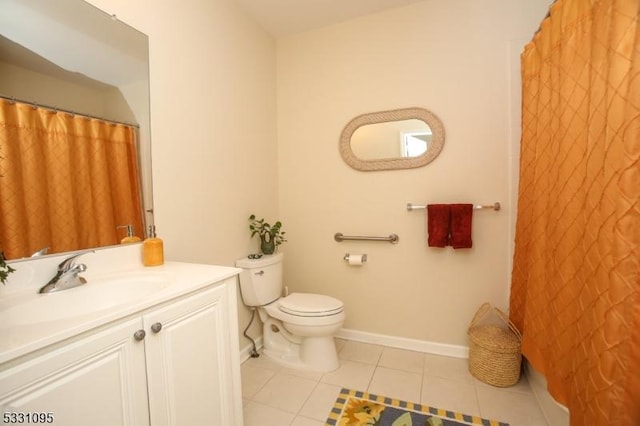 bathroom with tile patterned flooring, vanity, and toilet