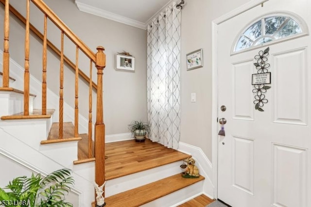 foyer featuring hardwood / wood-style floors and ornamental molding